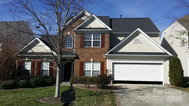 a front view of a house with a garden and plants