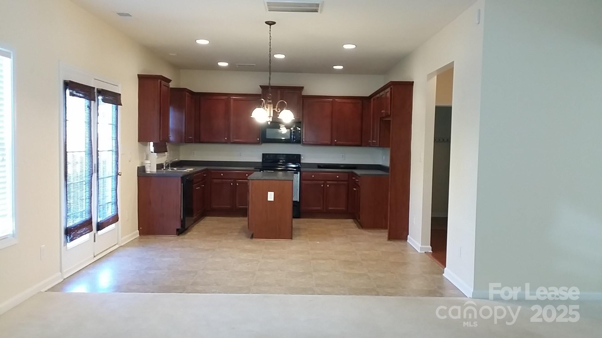 1595 Tranquility Avenue Northwest Concord, NC 28027 - Photo 6 of 14 a kitchen with kitchen island a sink appliances and cabinets