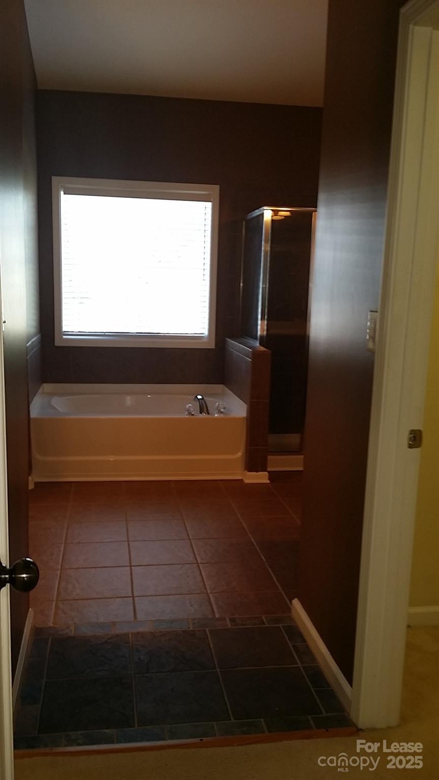 1595 Tranquility Avenue Northwest Concord, NC 28027 - Photo 8 of 14 a bathroom with a bathtub