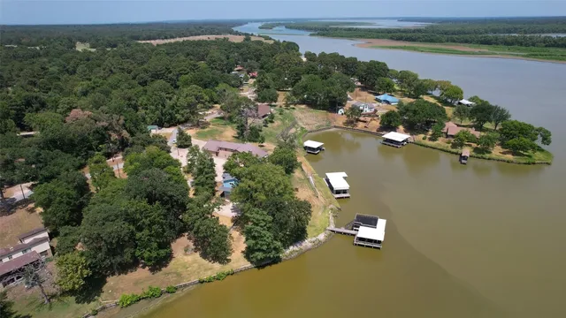 an aerial view of a house with a lake view