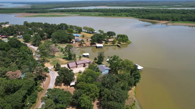 an aerial view of lake and residential houses with outdoor space