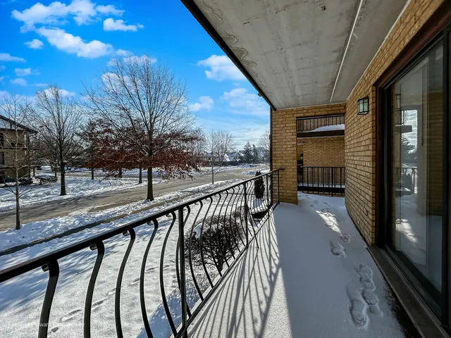 a view of balcony with wooden floor and fence