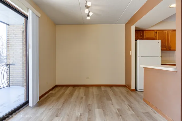 a view of a room with wooden floor and a window