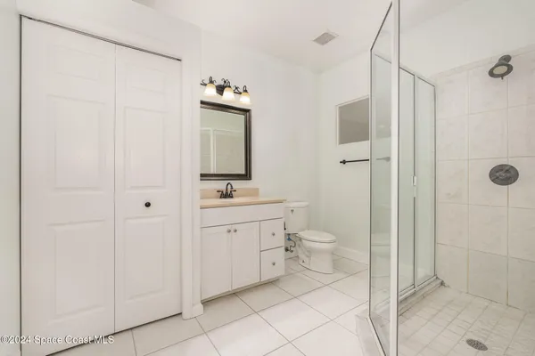 a spacious bathroom with a toilet sink and shower