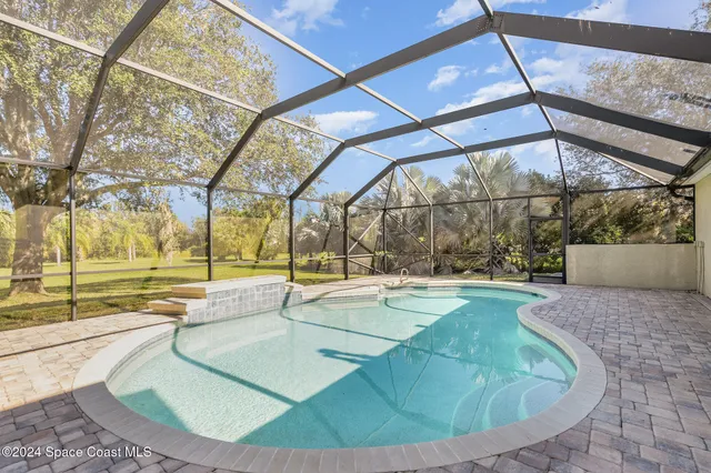 a view of a swimming pool with a patio