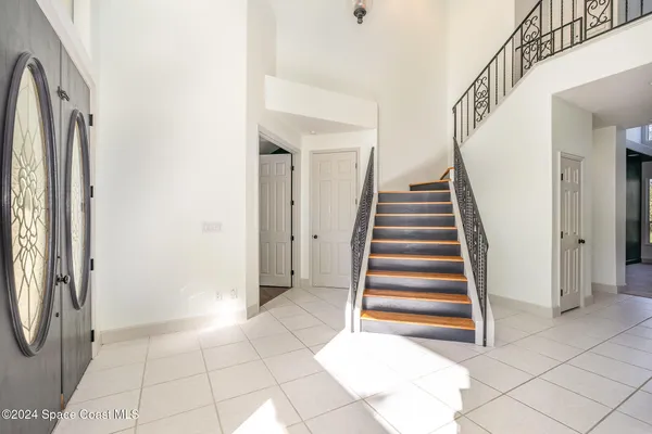 a view of entryway and hall with a door