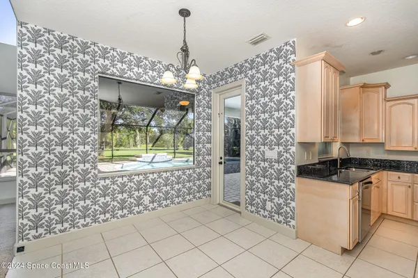 a kitchen with granite countertop a sink and a stove