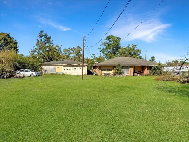 a view of an house with backyard space and balcony