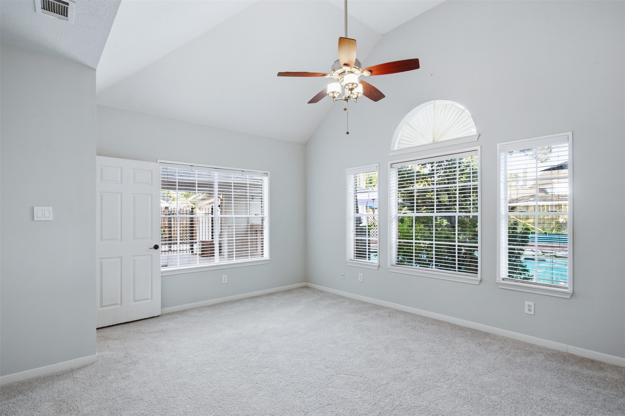 323 Magic Oaks Court Spring, TX 77388 - Photo 23 of 49 Located on the first floor, the primary bedroom boasts a view of the pool and entertaining area in the backyard.