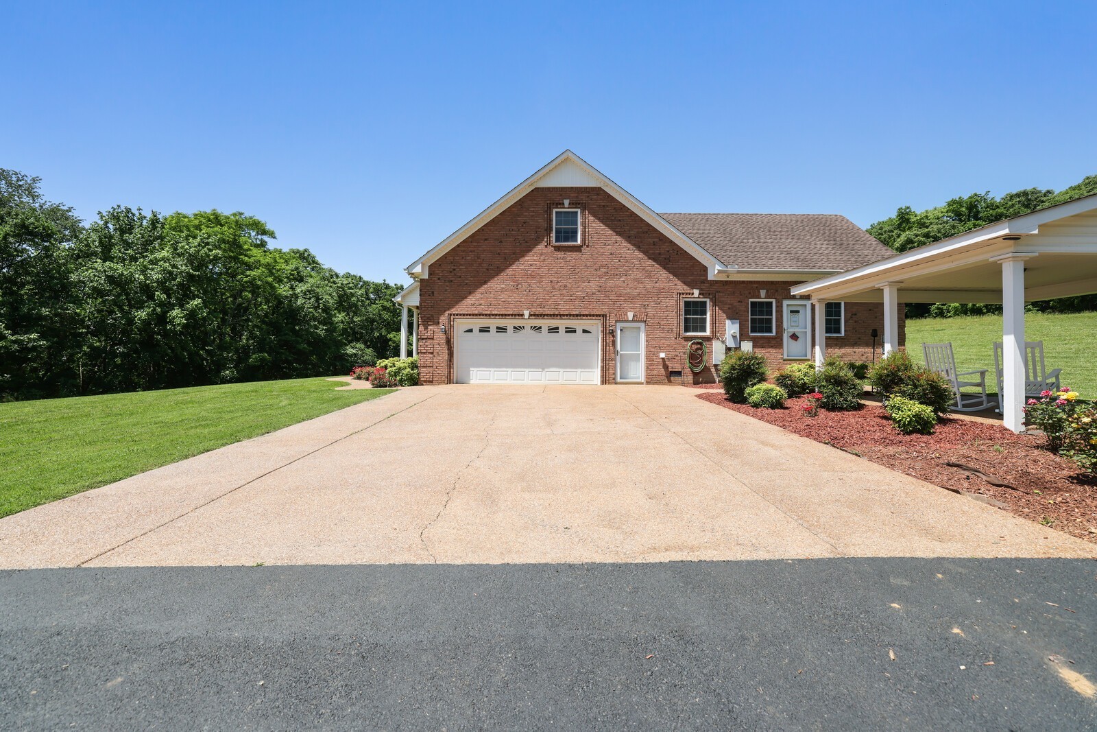 2219 Mack Benderman Road Culleoka, TN 38451 - Photo 29 of 40 a front view of a house with a yard and potted plants