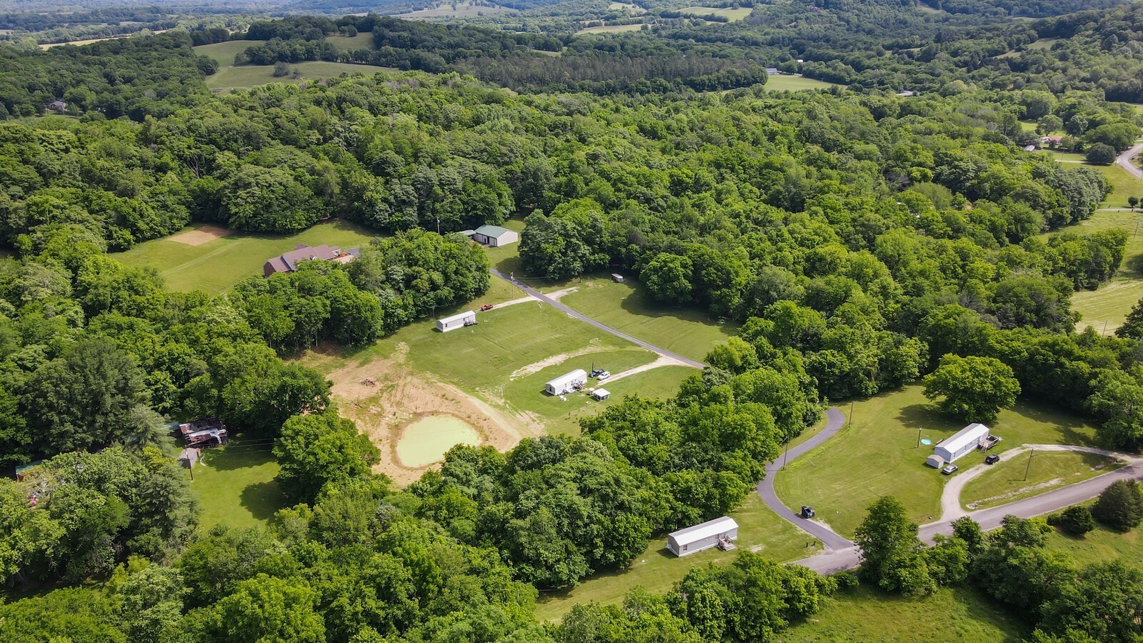 2219 Mack Benderman Road Culleoka, TN 38451 - Photo 37 of 40 an aerial view of a house with a yard and lake view