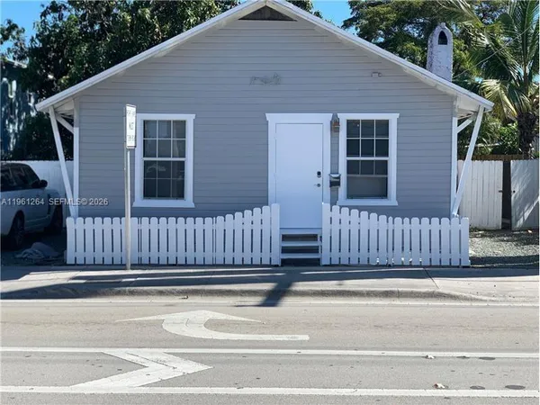 a view of a deck with a floor to ceiling window and wooden fence
