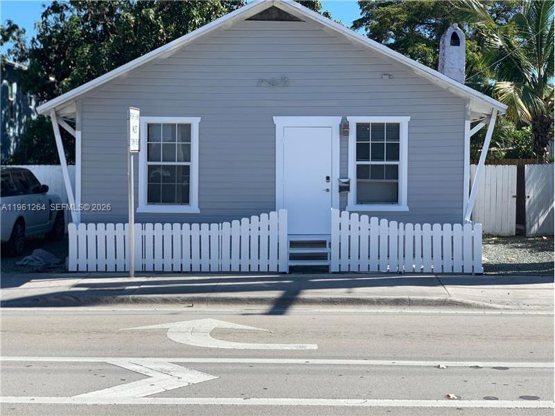 a view of a deck with a floor to ceiling window and wooden fence