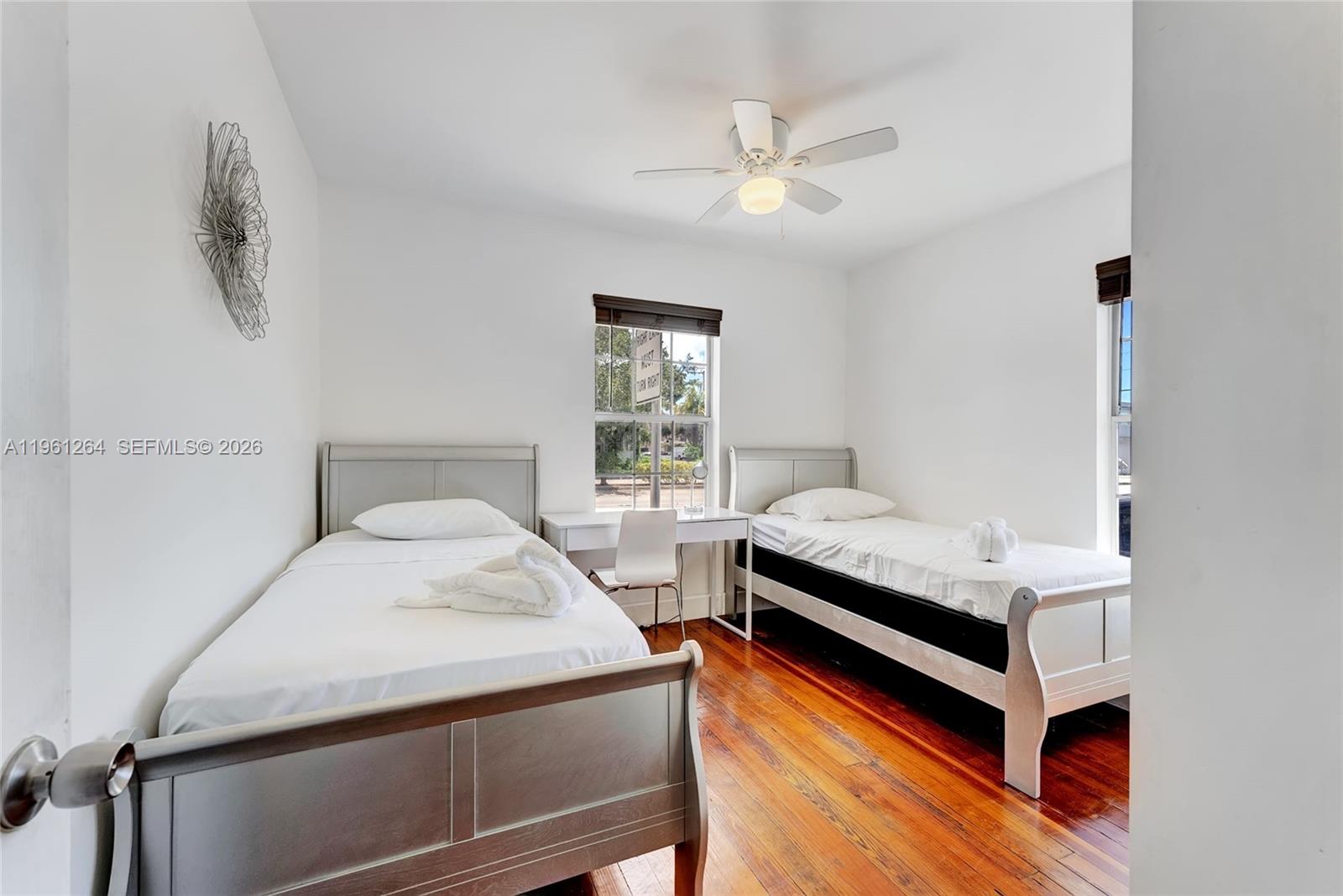 107 Stirling Road Dania Beach, FL 33004 - Photo 11 of 17 a bedroom with 2 bed and a window