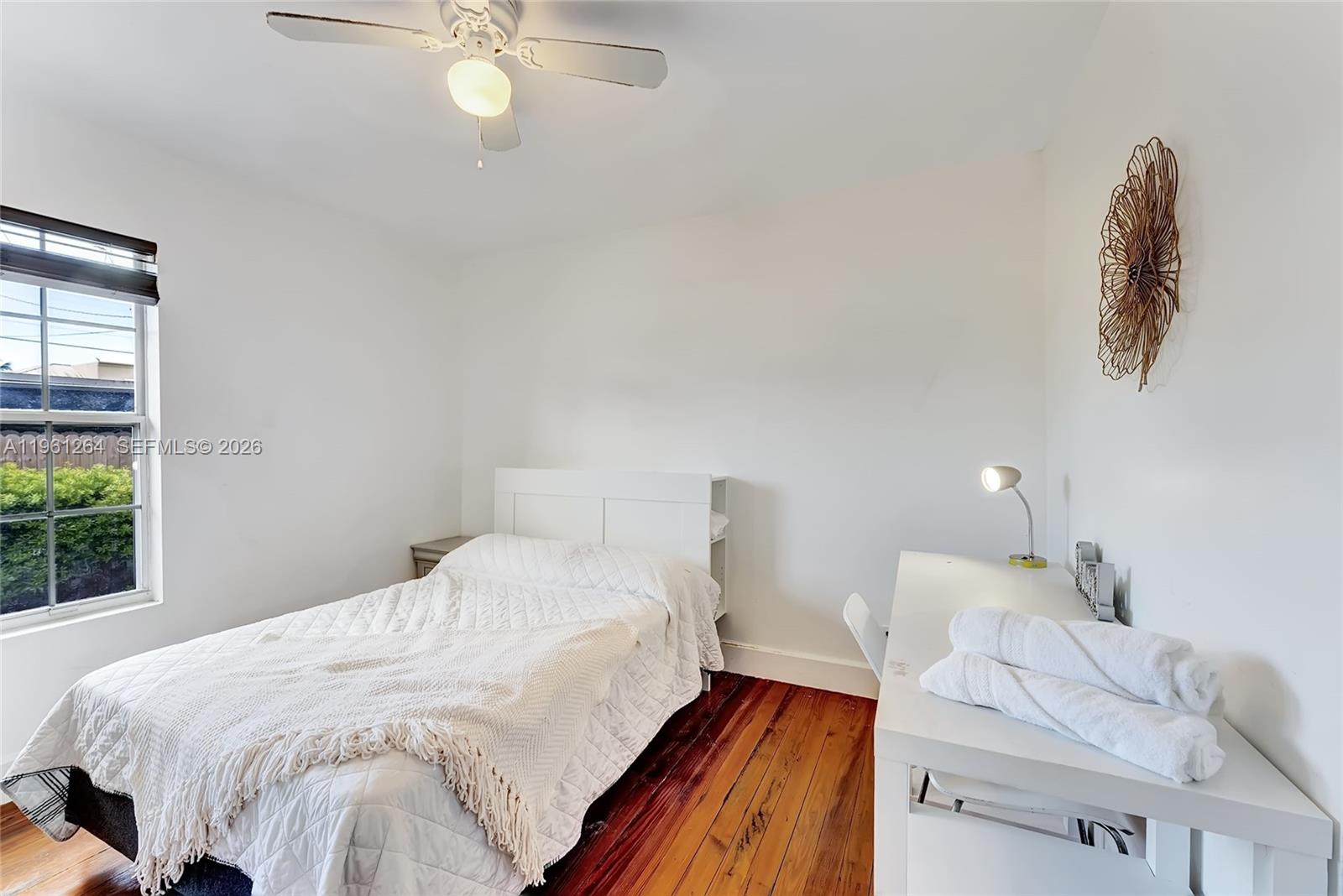 107 Stirling Road Dania Beach, FL 33004 - Photo 12 of 17 a bedroom with a bed and window