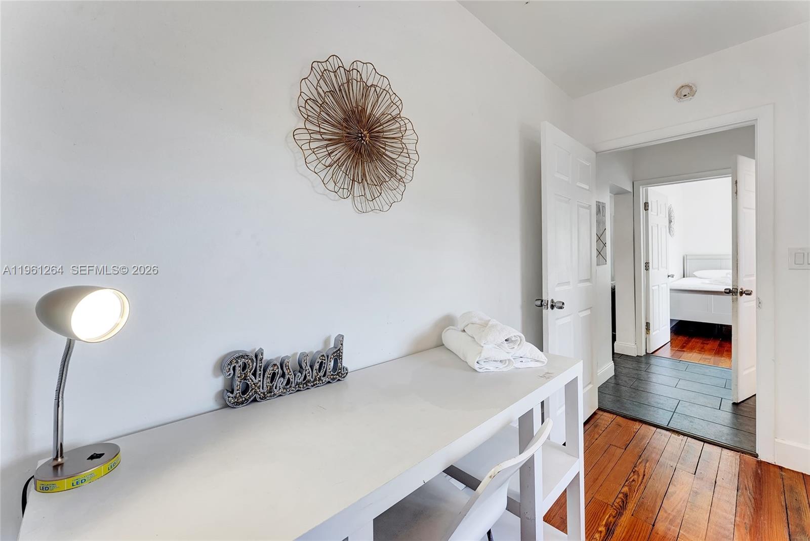 107 Stirling Road Dania Beach, FL 33004 - Photo 13 of 17 a workspace with furniture and wooden floor