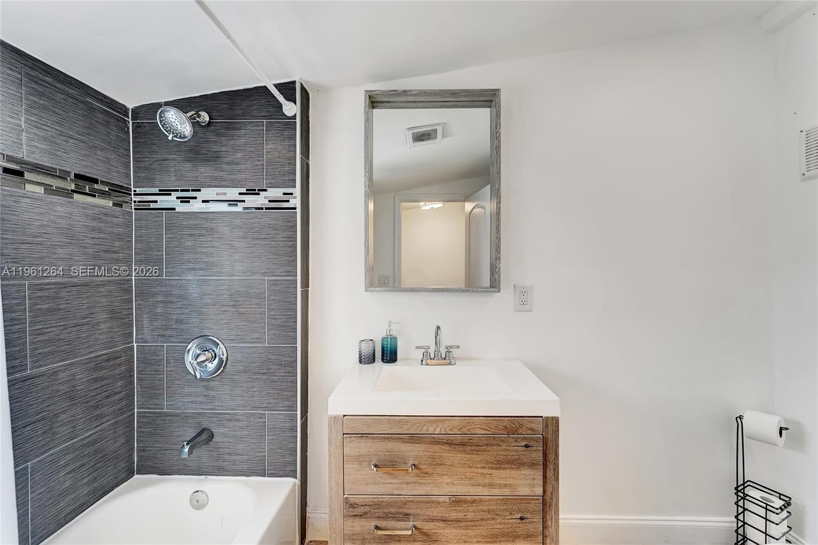 107 Stirling Road Dania Beach, FL 33004 - Photo 14 of 17 a bathroom with a sink a toilet and shower