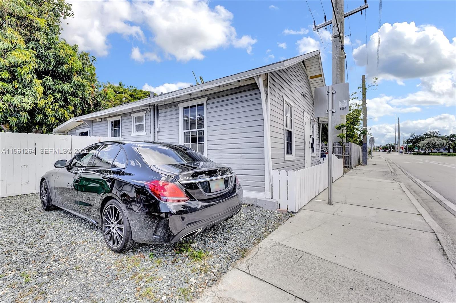 107 Stirling Road Dania Beach, FL 33004 - Photo 2 of 17 a car parked in front of a house
