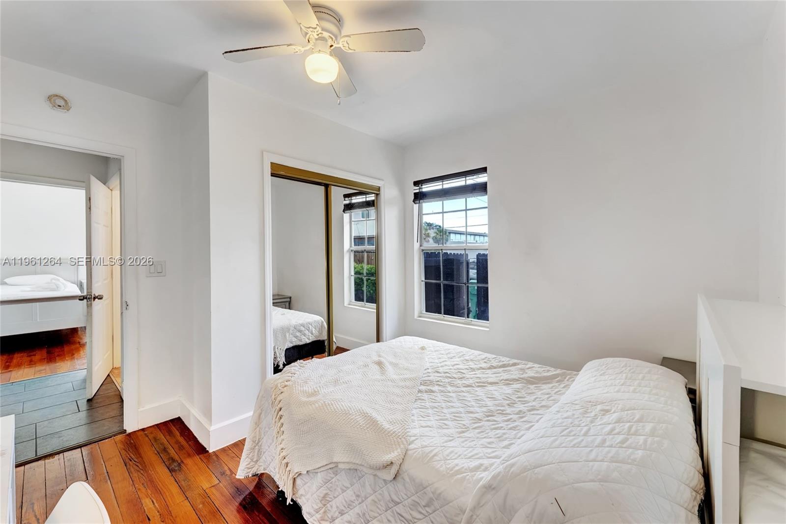 107 Stirling Road Dania Beach, FL 33004 - Photo 10 of 17 a bedroom with a bed and a large window