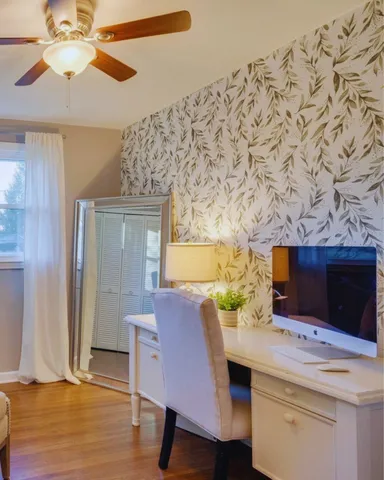 a view of a dining room with furniture and wooden floor