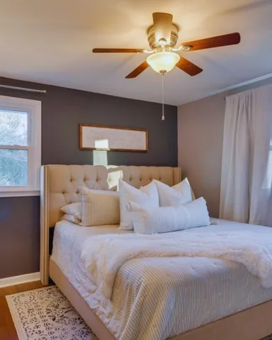 a bedroom with a large bed and a chandelier
