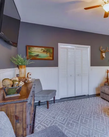 a living room with furniture and flowers