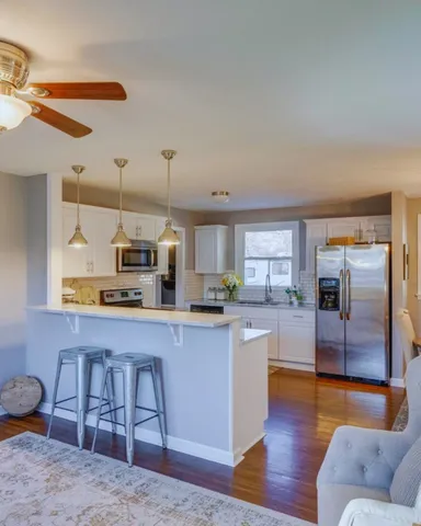 a kitchen with stainless steel appliances granite countertop a sink and a refrigerator