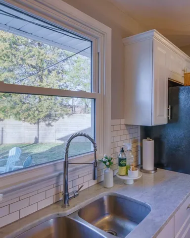 a kitchen with granite countertop a sink and a window
