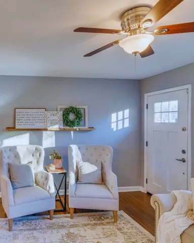 a living room with furniture and a chandelier