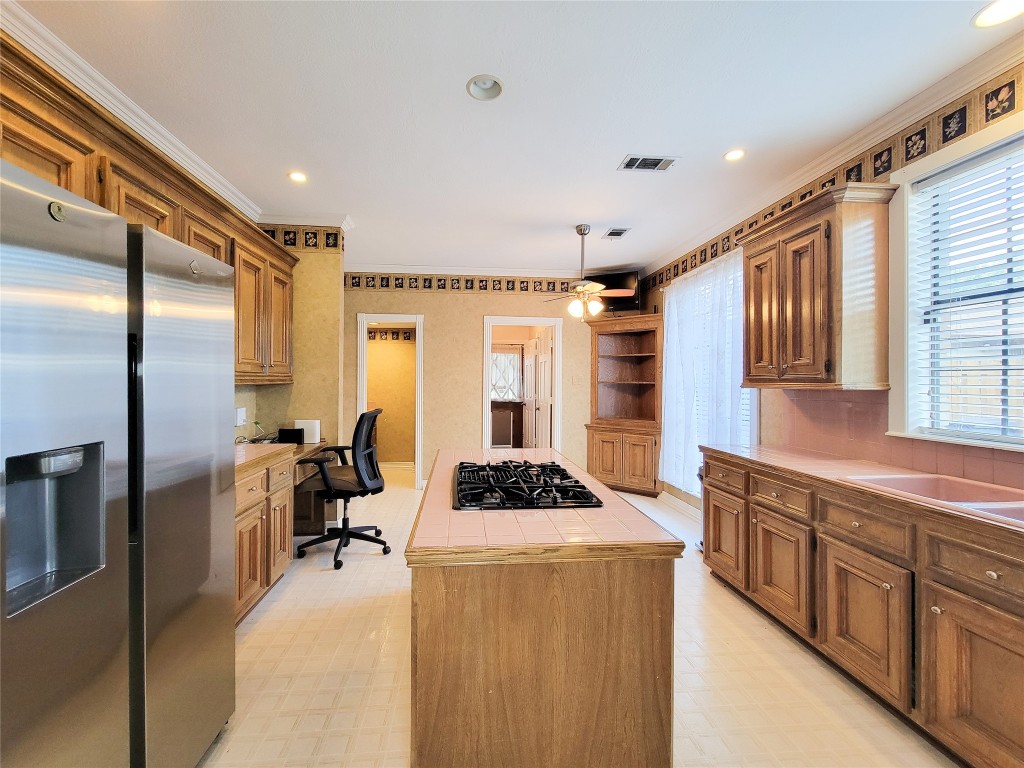 5810 Glenmere Lane Spring, TX 77379 - Photo 13 of 46 a kitchen with stainless steel appliances kitchen island granite countertop a refrigerator and a stove top oven