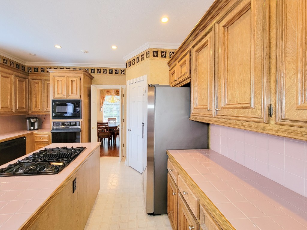 5810 Glenmere Lane Spring, TX 77379 - Photo 14 of 46 a kitchen with a refrigerator a stove and a sink