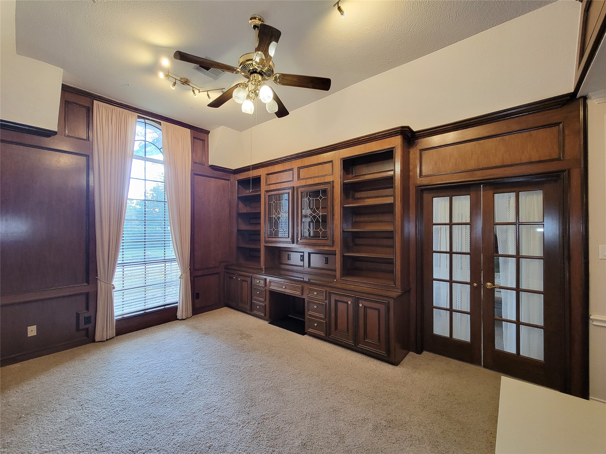 5810 Glenmere Lane Spring, TX 77379 - Photo 19 of 46 a view of an empty room with a fireplace and windows