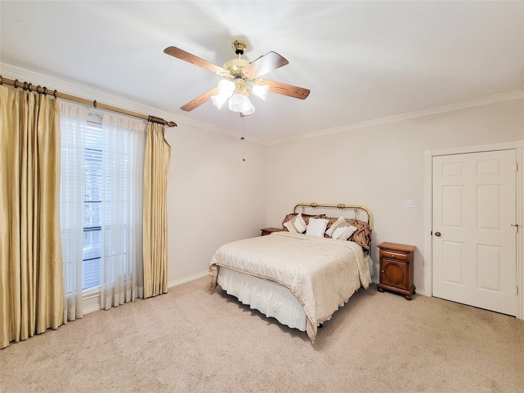 5810 Glenmere Lane Spring, TX 77379 - Photo 29 of 46 a spacious bedroom with a bed and a chandelier