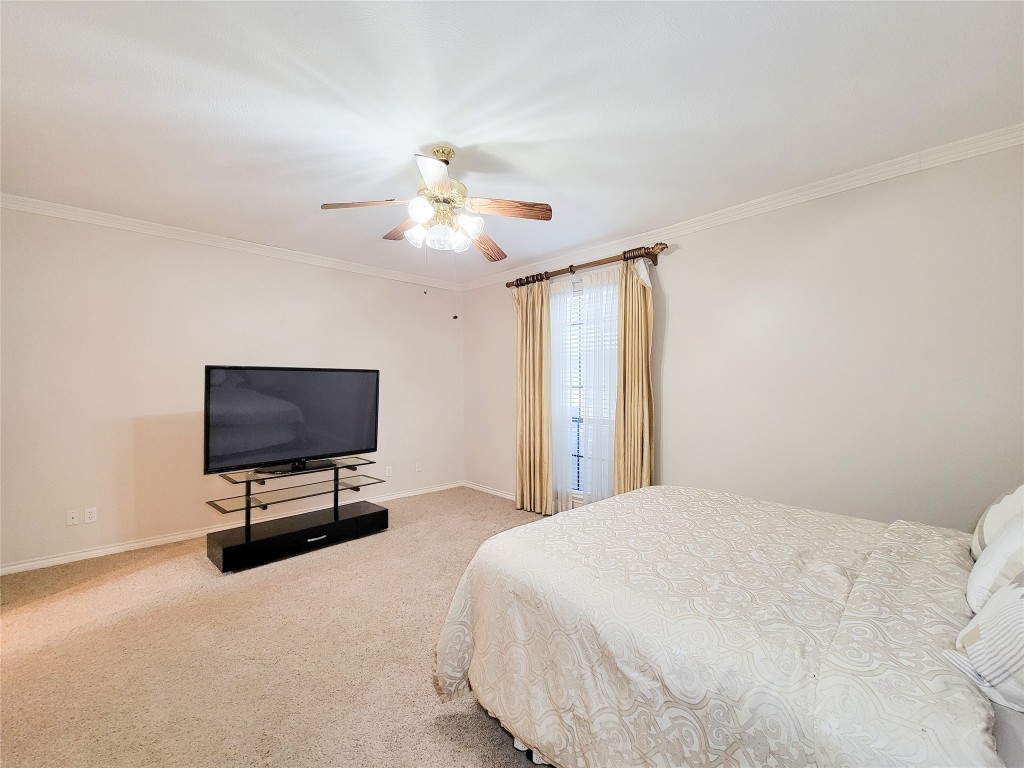 5810 Glenmere Lane Spring, TX 77379 - Photo 30 of 46 a bedroom with a bed tv and chair