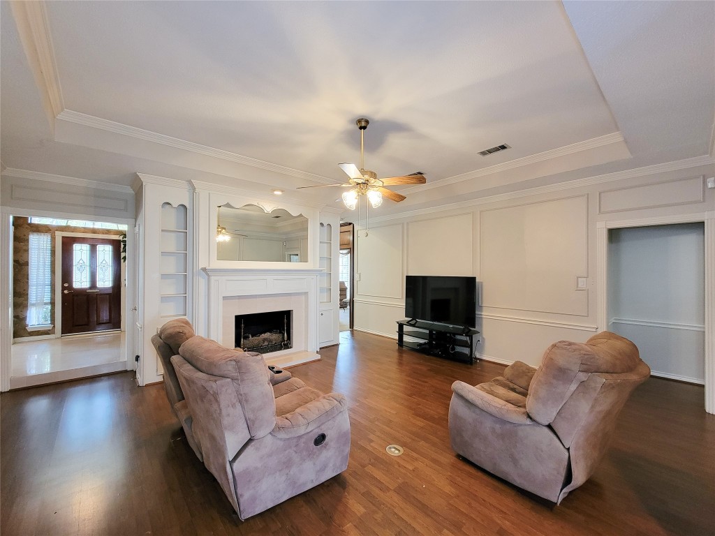 5810 Glenmere Lane Spring, TX 77379 - Photo 3 of 46 a living room with furniture a fireplace and a flat screen tv