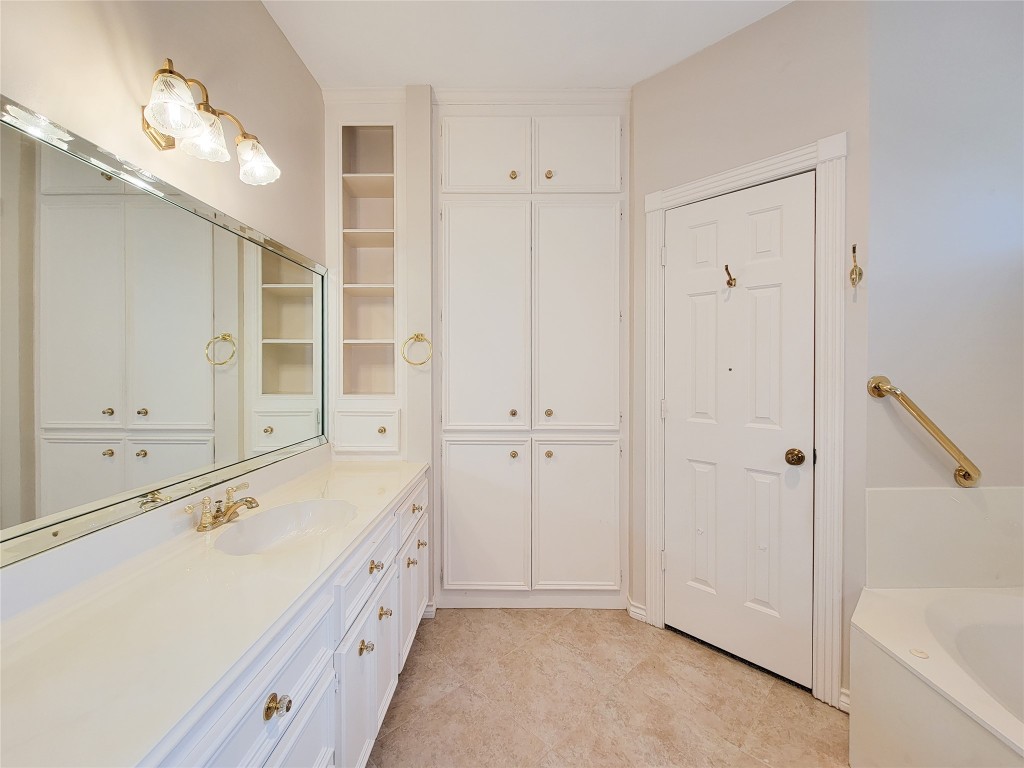 5810 Glenmere Lane Spring, TX 77379 - Photo 32 of 46 a large white bathroom with a tub sink and mirror