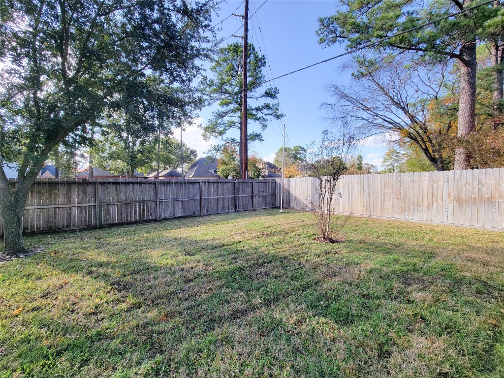 5810 Glenmere Lane Spring, TX 77379 - Photo 43 of 46 a backyard of a house with a yard and wooden fence