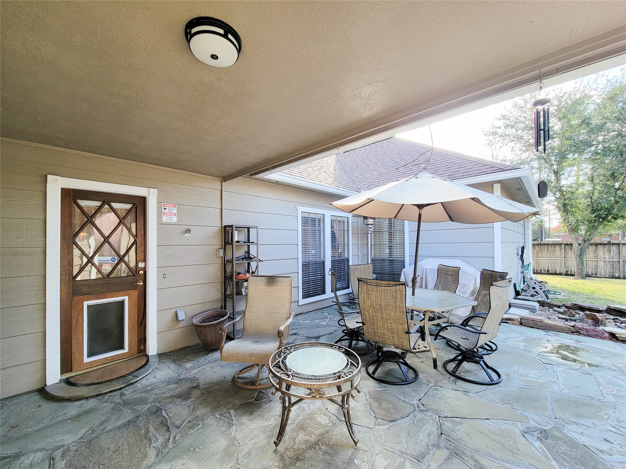 5810 Glenmere Lane Spring, TX 77379 - Photo 45 of 46 a living room with furniture a fireplace and a floor to ceiling window