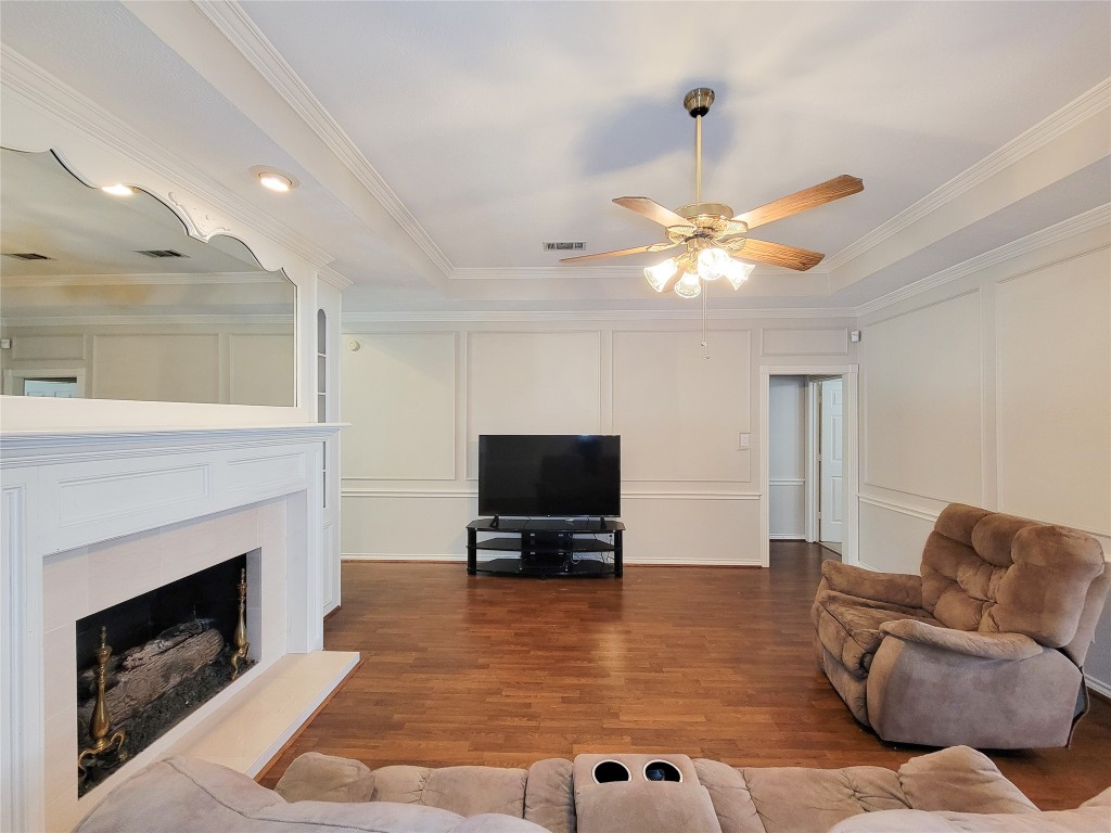 5810 Glenmere Lane Spring, TX 77379 - Photo 6 of 46 a living room with furniture a fireplace and a flat screen tv