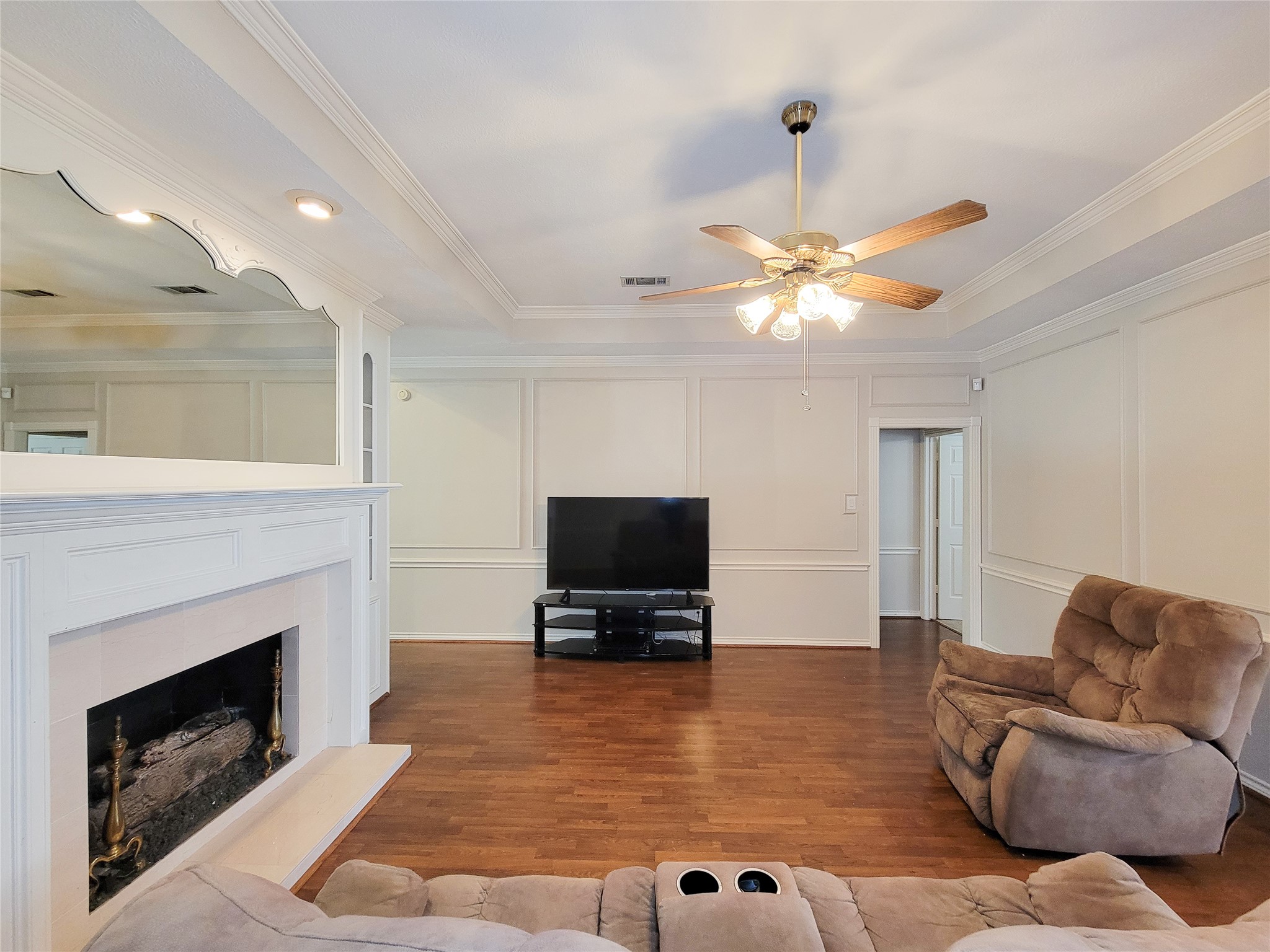 5810 Glenmere Lane Spring, TX 77379 - Photo 6 of 46 a living room with furniture a fireplace and a flat screen tv