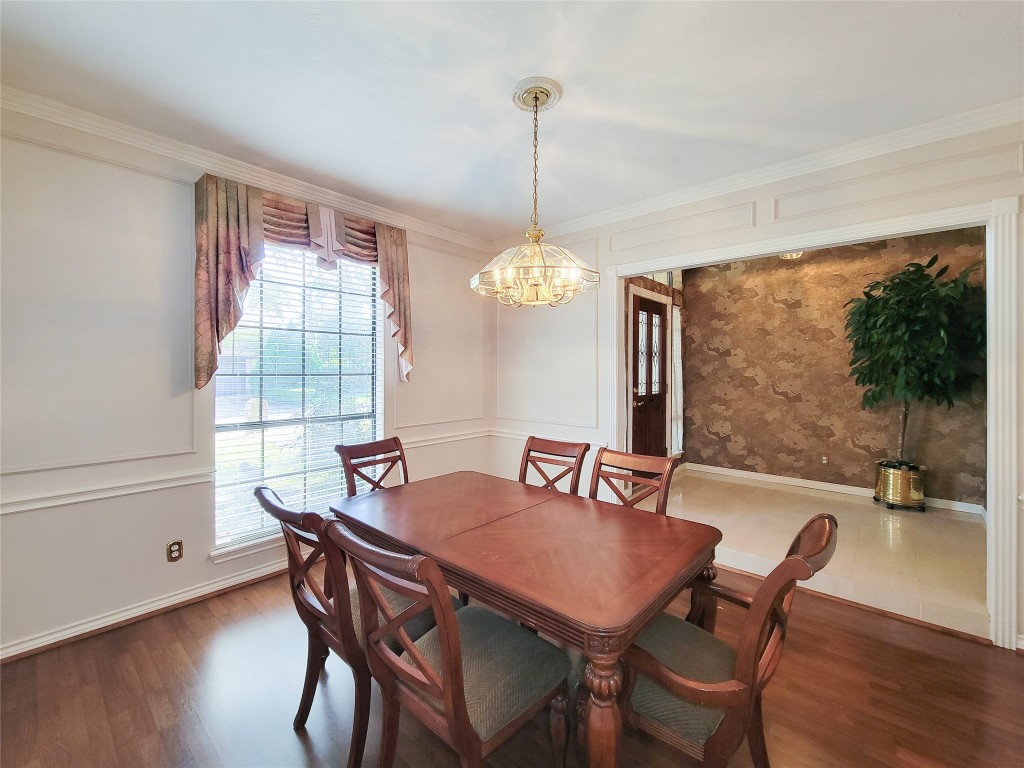 5810 Glenmere Lane Spring, TX 77379 - Photo 9 of 46 a dining room with furniture a chandelier and wooden floor