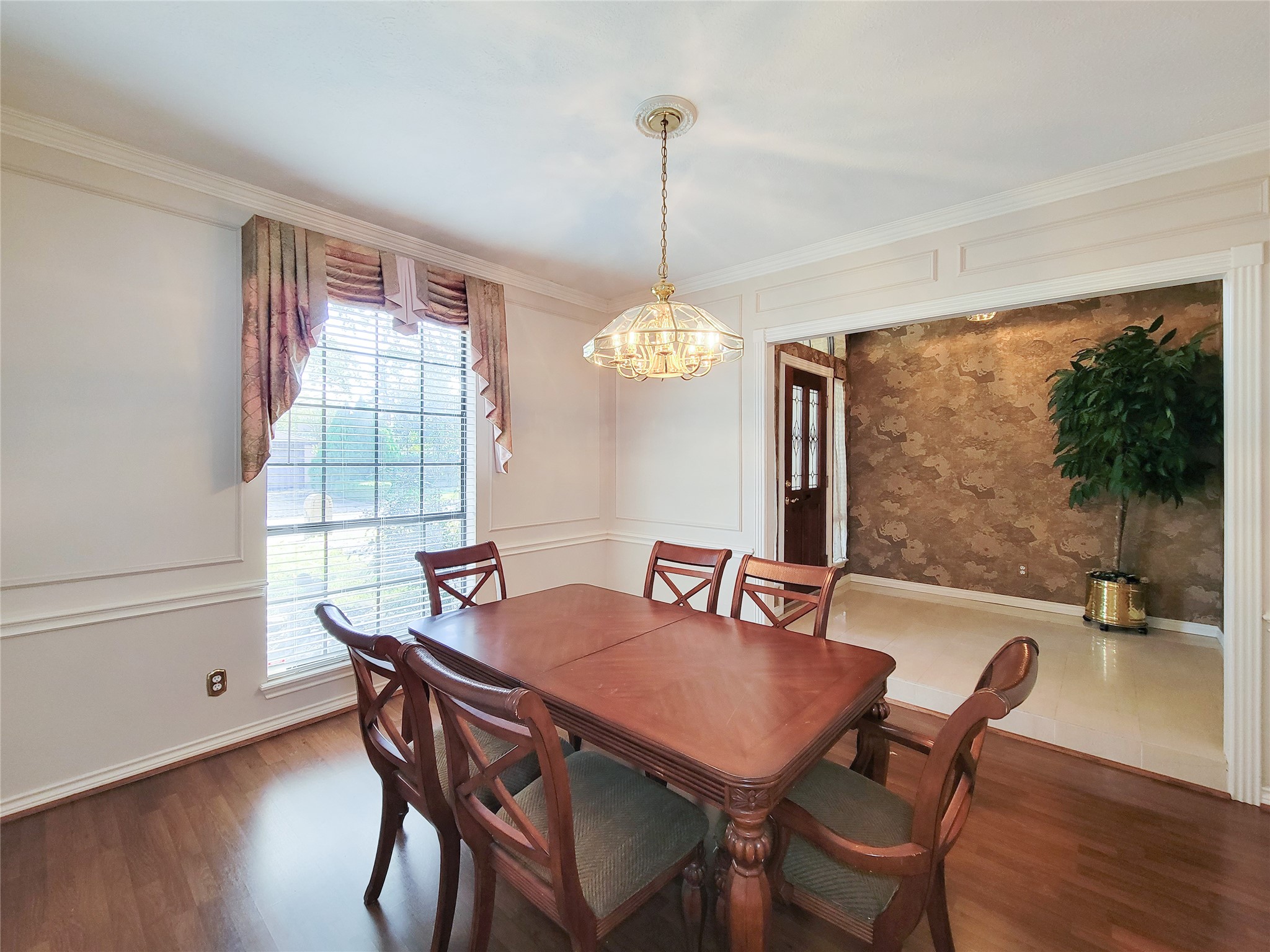 5810 Glenmere Lane Spring, TX 77379 - Photo 9 of 46 a dining room with furniture a chandelier and wooden floor