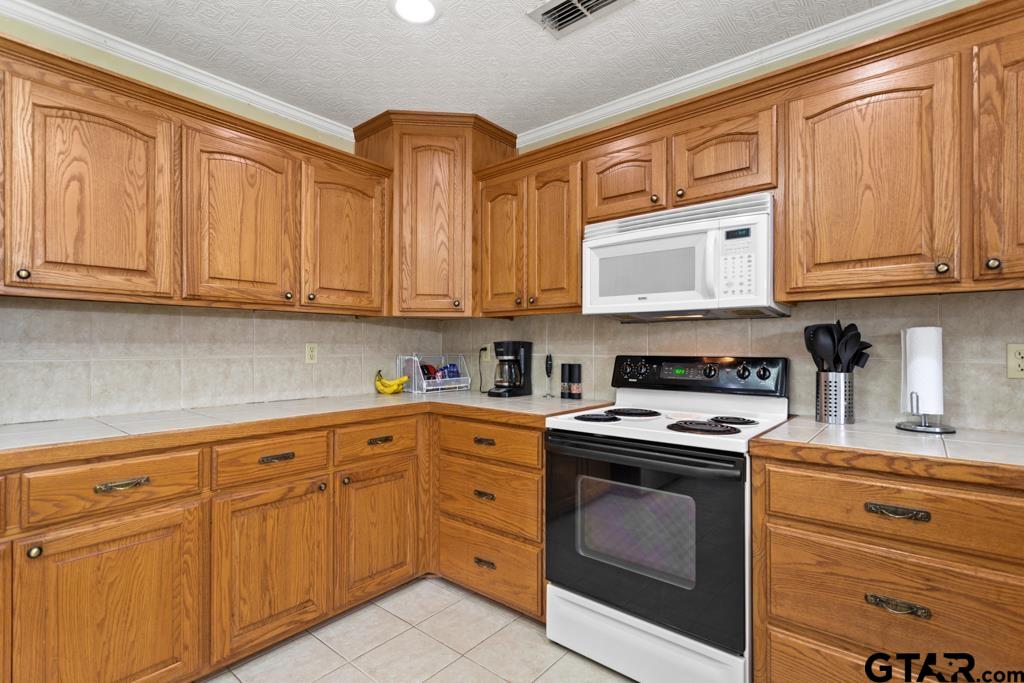 448 North Hill Road Tyler, TX 75706 - Photo 9 of 30 a kitchen with granite countertop cabinets stainless steel appliances and a sink