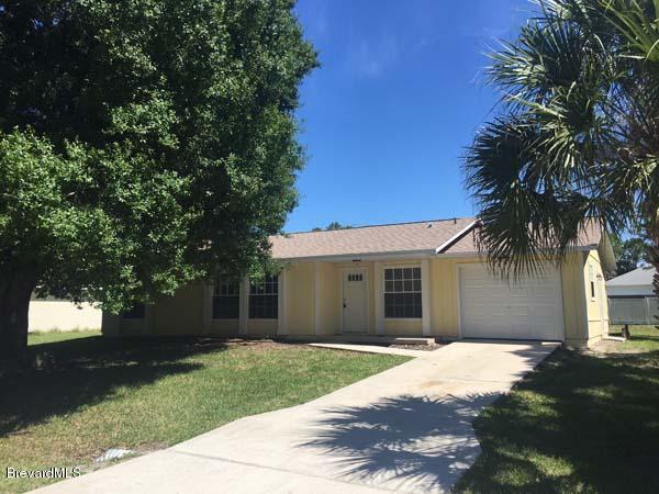 630 Weaver Road Southwest Palm Bay, FL 32908 - Photo 1 of 11 a front view of house with yard and green space