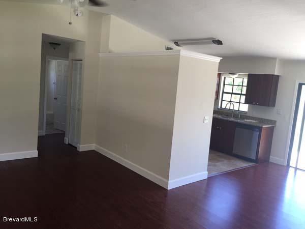 630 Weaver Road Southwest Palm Bay, FL 32908 - Photo 2 of 11 an empty room with wooden floor and a window