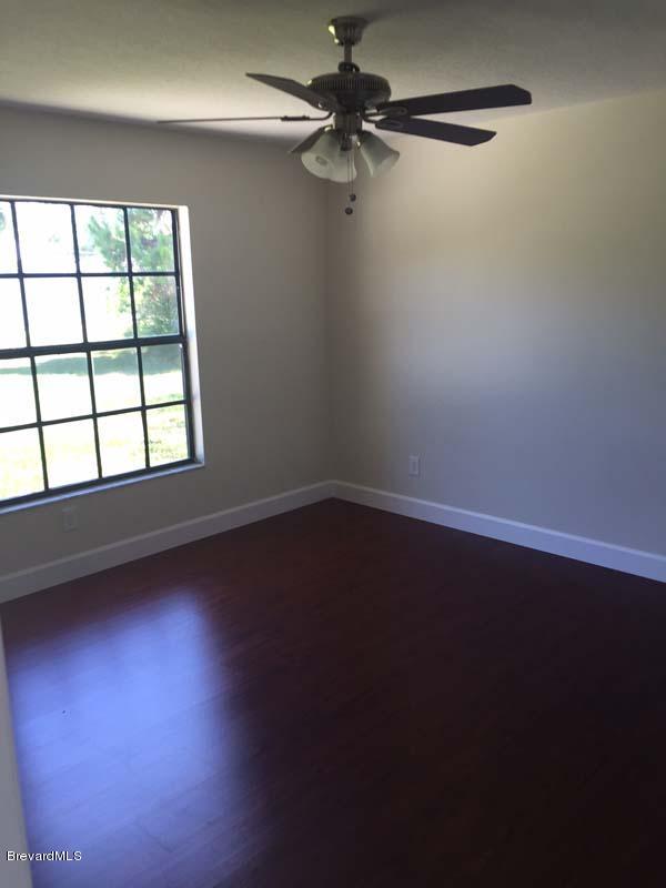 630 Weaver Road Southwest Palm Bay, FL 32908 - Photo 4 of 11 an empty room with a window
