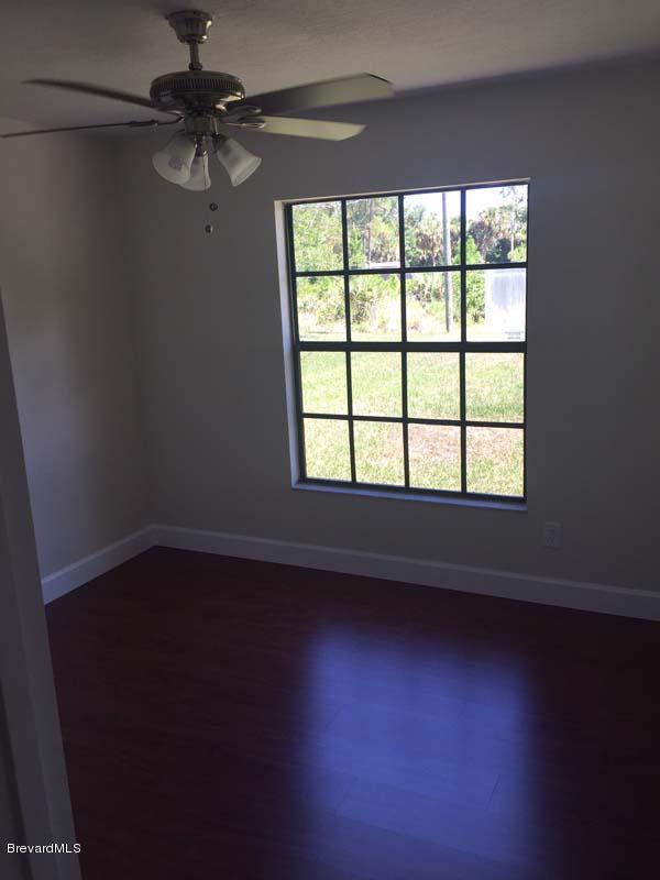 630 Weaver Road Southwest Palm Bay, FL 32908 - Photo 5 of 11 an empty room with a window
