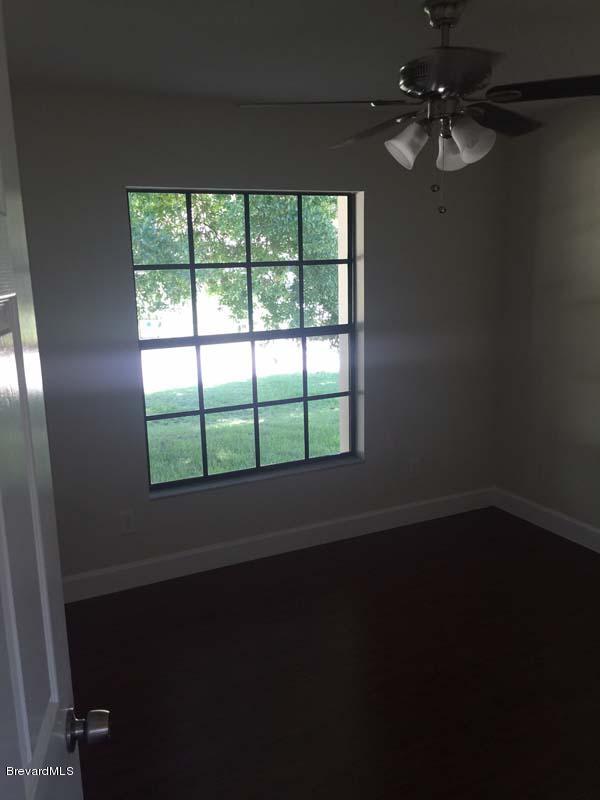 630 Weaver Road Southwest Palm Bay, FL 32908 - Photo 6 of 11 a view of wooden floor in an empty room with a window