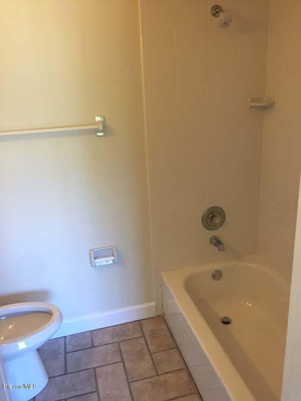 630 Weaver Road Southwest Palm Bay, FL 32908 - Photo 7 of 11 a bathroom with a granite countertop toilet and a bathtub