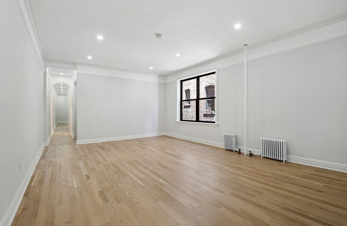 575 Riverside Drive, Unit 42 Manhattan, NY 10031 - Photo 2 of 12 a view of empty room with wooden floor and fan